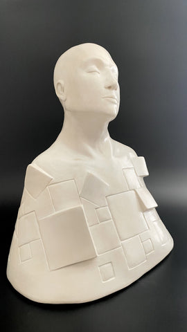 Large white ceramic sculpture representing the pieces that make a person. White. Entitled Tranquility