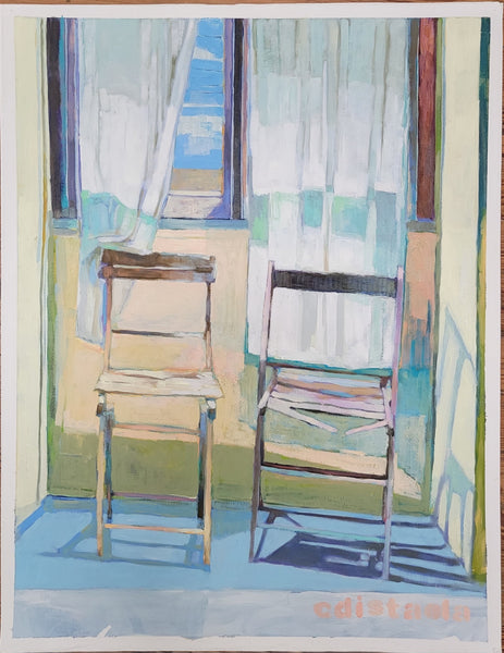 two empty chars sit side by side under a window with white curtains blowing in the wind