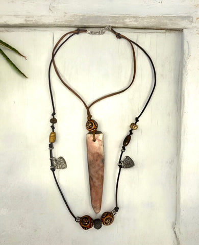 Primitive pendant on leather strand