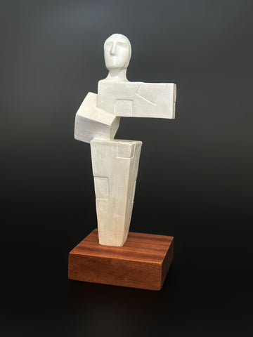 Large white ceramic sculpture representing the pieces that make a person. White. Entitled Balance