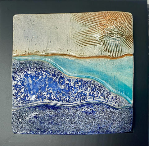 ceramic tile; water heading out to sea; sun. framed 8x8