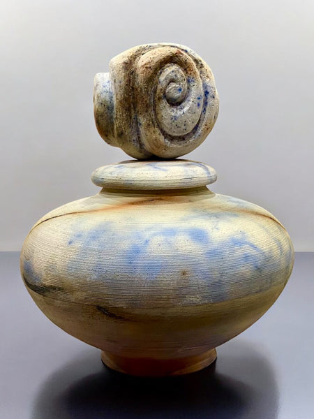 saggar fired vessel with hand carved clay lid representing circle of life