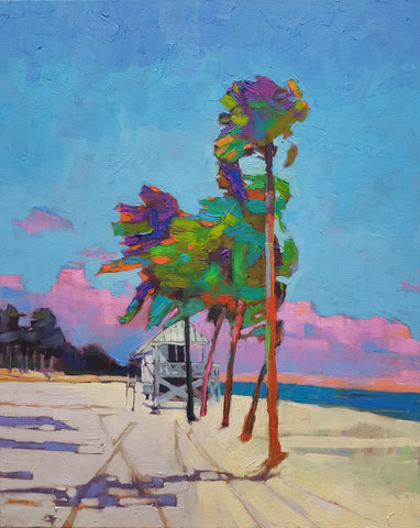 palm cluster in the wind with lifeguard house in background backed by a pink and blue sky 