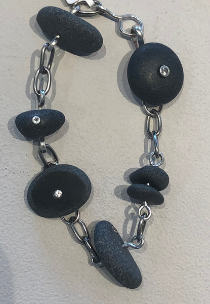 basalt stone bracelet featuring white topaz set in each of the 7 stones