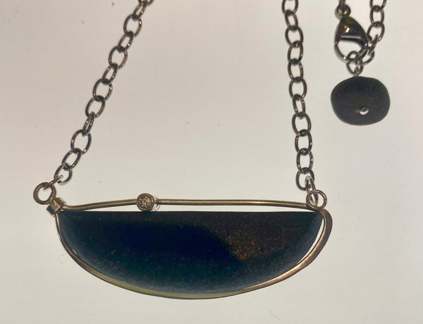 basalt stone two sided boat pendant with white topaz and citrine accent gemstones on a sterling silver chain