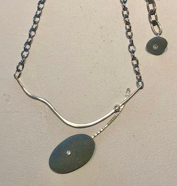 double curved basalt necklace with hand hammered silver and white topaz