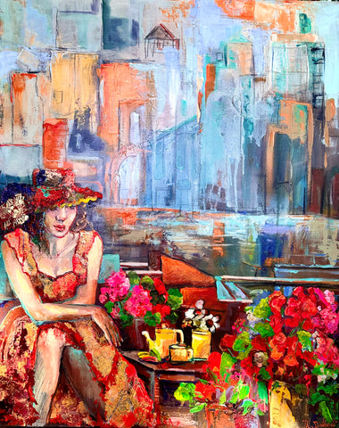 woman in a hat and red dress sitting at a riverside cafe with a teapot and cup  of tea, two flower bouquets nearby behind her you can see the city skyline
