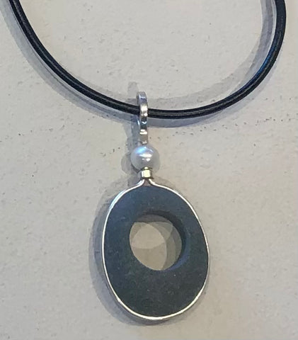 simple basalt stone and pearl pendant on a leather cord