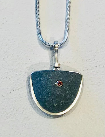 soft triangle pendant with garnet accent on a sterling silver chain