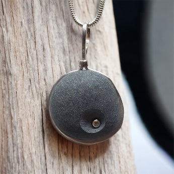basalt pendant with white topaz wrapped with sterling silver on a silver chain